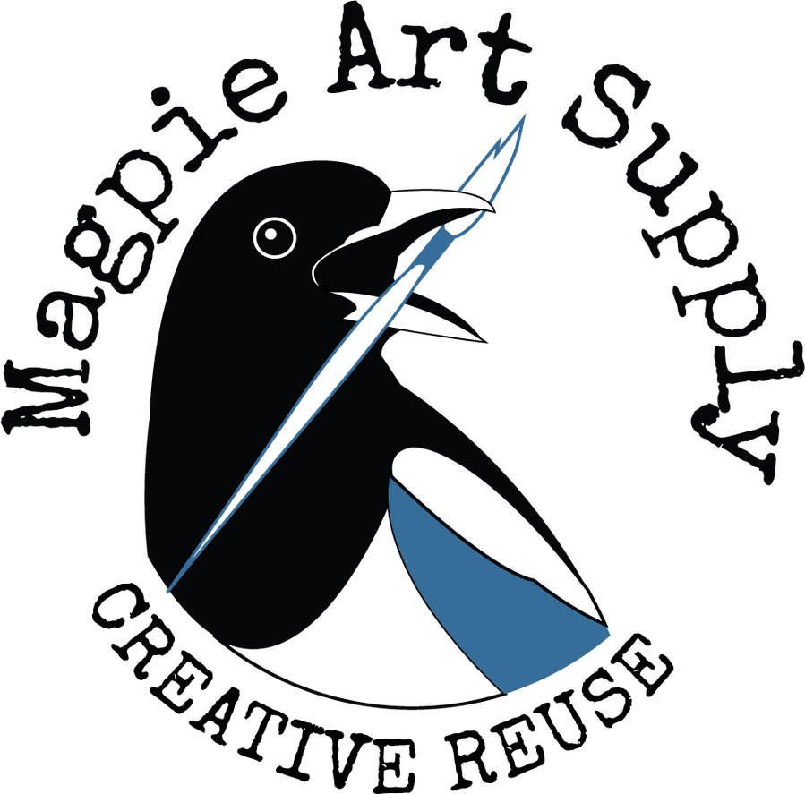 Magpie Art Supply logo is a magpie's black, white, and blue head and upper body looking to the right and holding a paint brush in its open beak