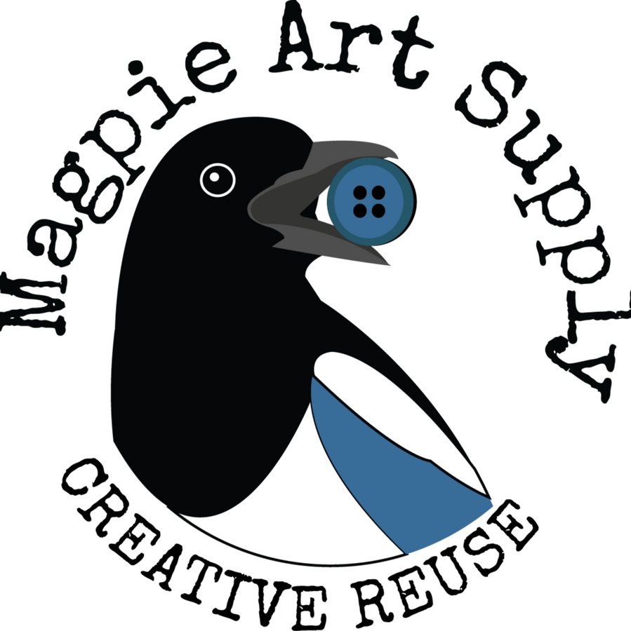 Magpie Art Supply logo is a magpie's black, white, and blue head and upper body looking to the right and holding a paint brush in its open beak