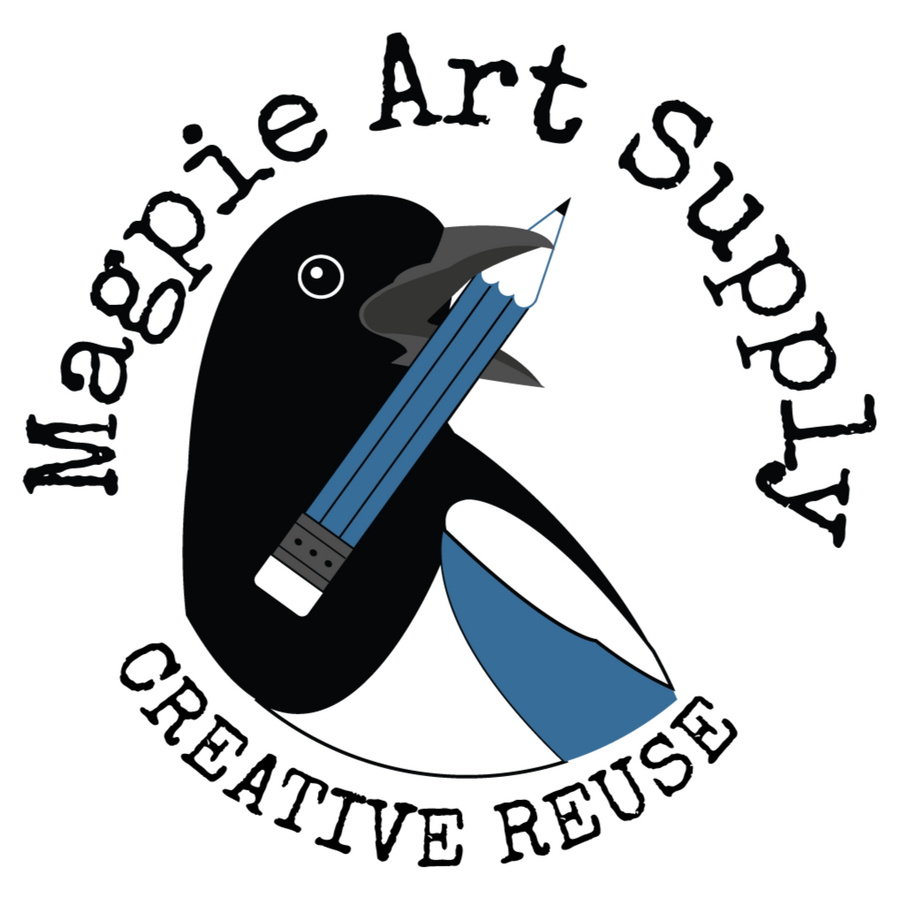 Magpie Art Supply logo is a magpie's black, white, and blue head and upper body looking to the right and holding a paint brush in its open beak
